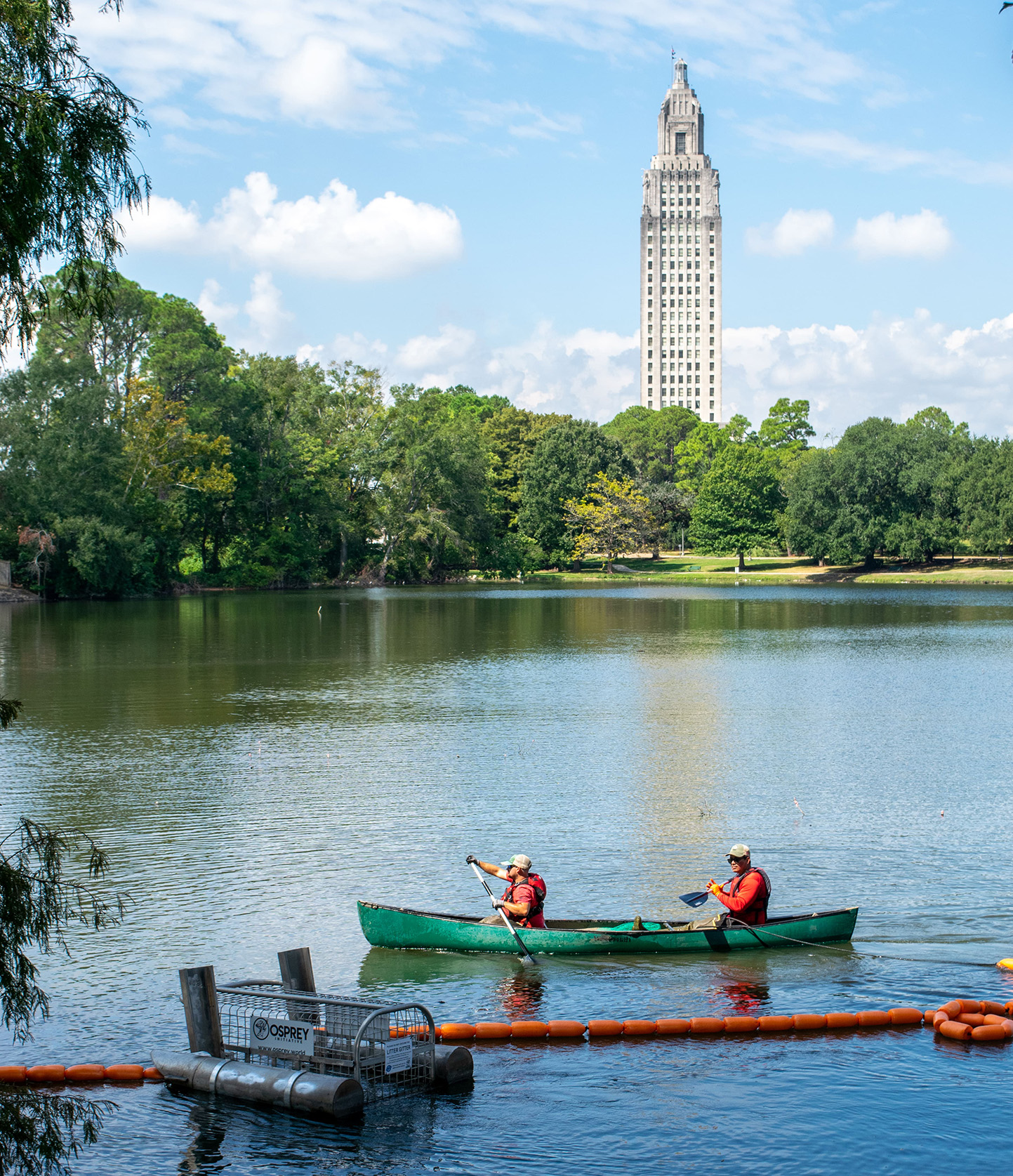 group of staff from Osprey Initiative install litter capture device at Capitol Lake