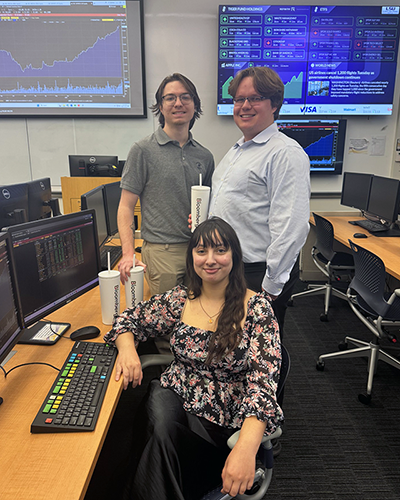 Landyn Sonnier, Brennan Davis, and Dakota Espinosa hold Bloomberg tumblers and smile at the camera in the SMART Lab. Placeholder Image