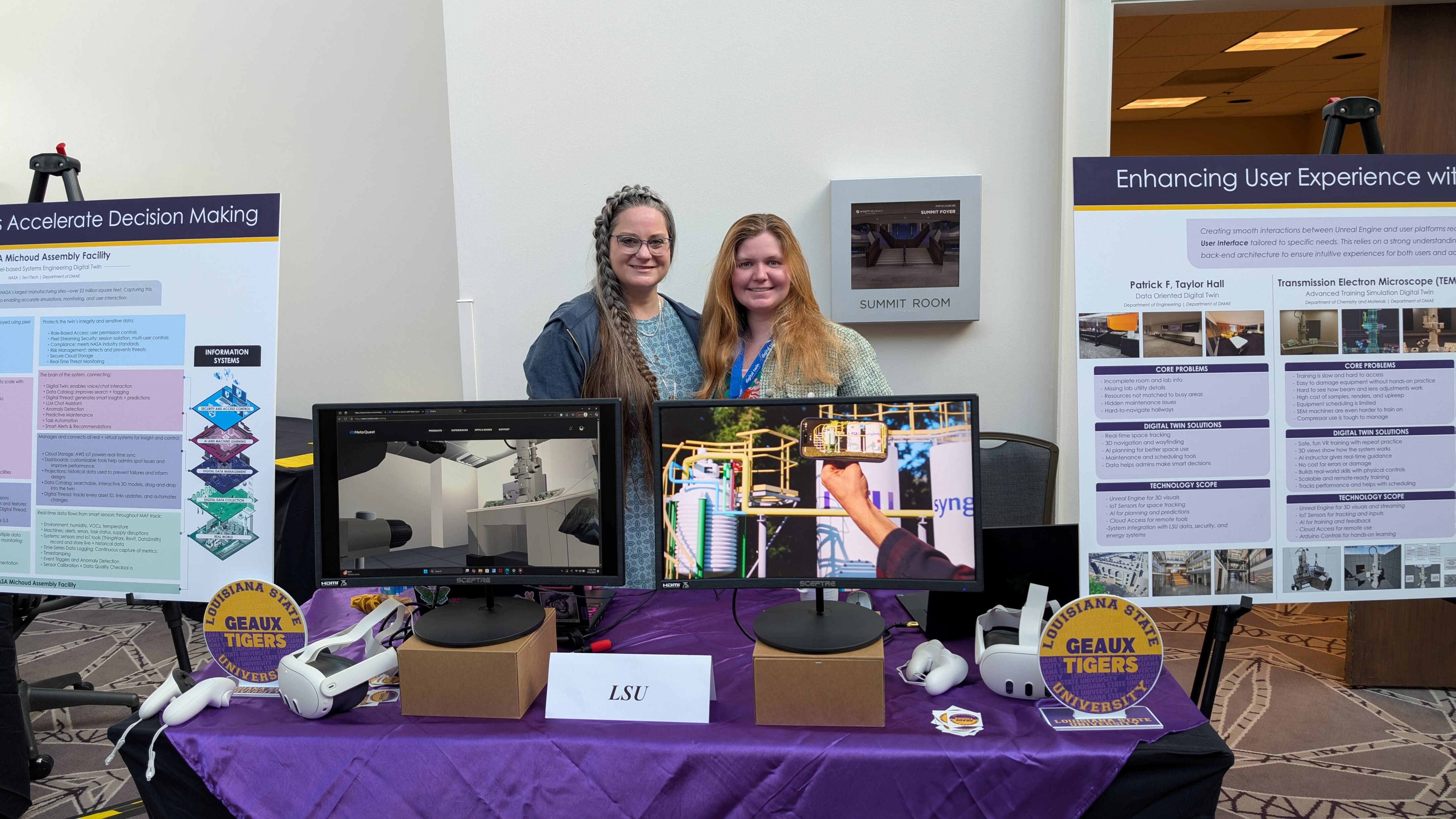 A picture of 2 graduate students presentng at the digital twin consortium conference.