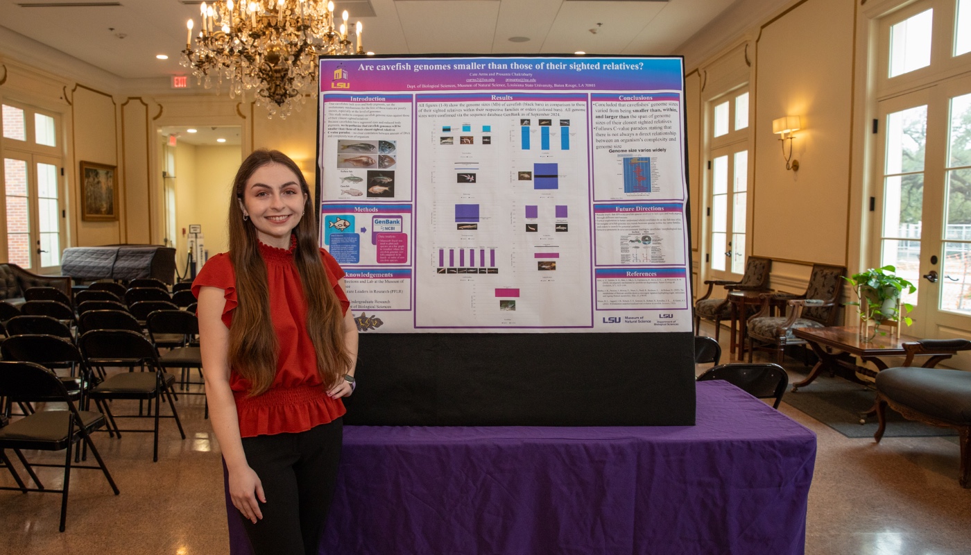 Photo of LSU Honors student Cate Arms in front of her capstone photo
