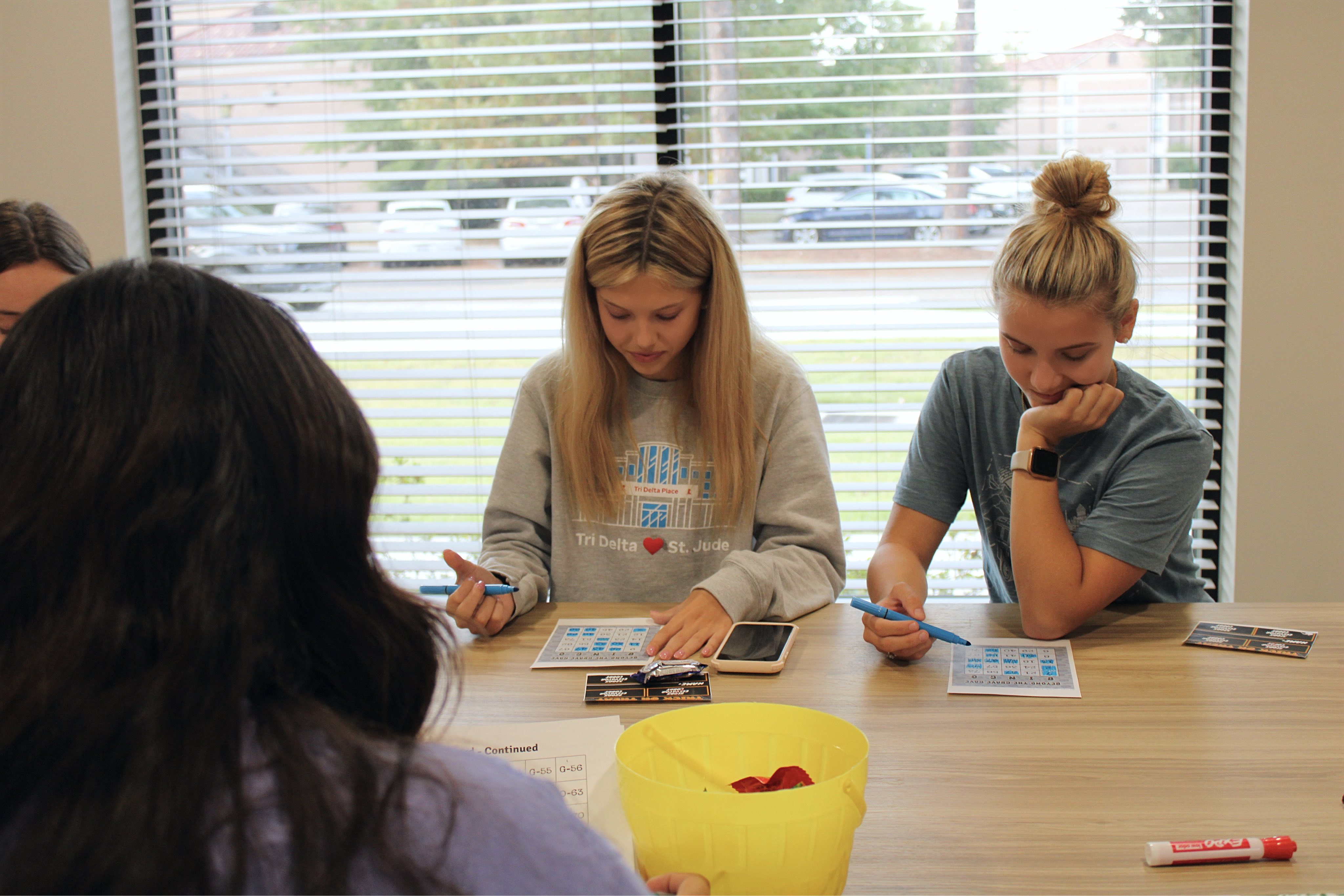Students playing bingo at an in-hall event.
