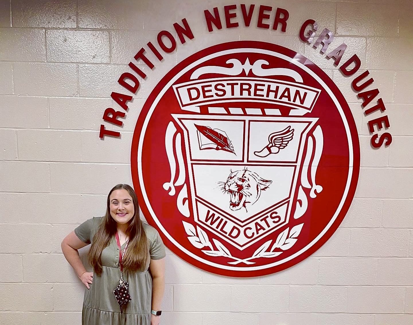 macy-lafleur-alma-mater Macy in the hallway posing in front of Destrehan High insignia